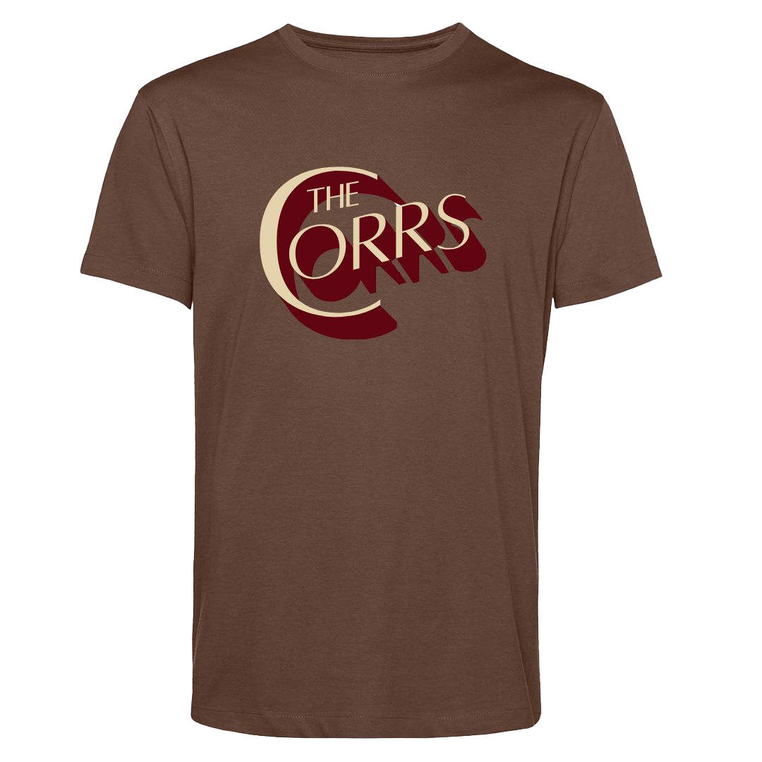 The Corrs Serif Brown T-Shirt from The Corrs Store by National Merchandise features large cream and maroon THE CORRS text on soft ring-spun combed fabric, shown against a bright green background.