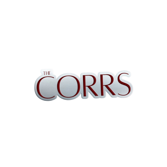 The image shows THE CORRS in large, bold letters with a white background and red outline, featured on The Corrs Pin Badge from The Corrs Store by National Merchandise.
