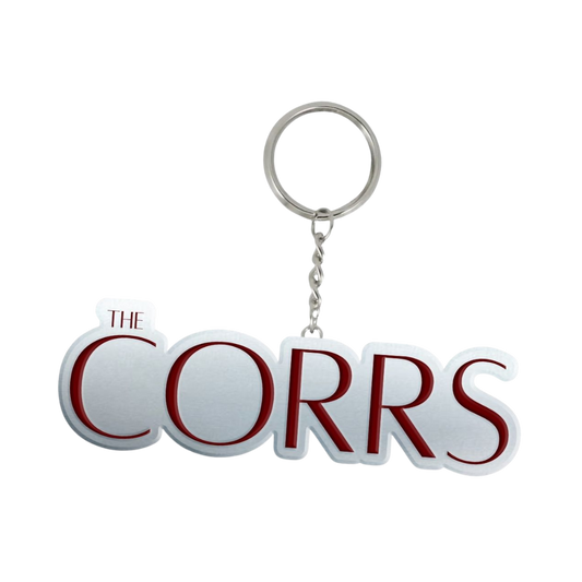 The Corrs Keyring from The Corrs Store by National Merchandise features a bold red embossed THE CORRS logo on a sturdy silver metal key ring.